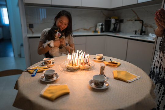 Woman celebrates birthday with family and dog