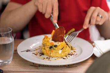 Man enjoying traditional Portuguese cod with cream