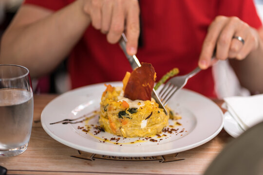 Man enjoying traditional Portuguese cod with cream