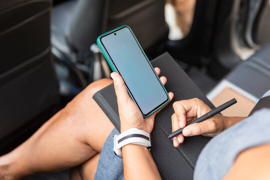 Businesswoman multitasking in a car