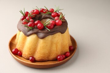Tasty Christmas cake with cranberries on light table, closeup. Space for text