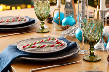 Festive table setting with Christmas decor at home, closeup