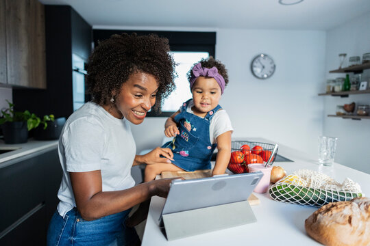 Mother and child enjoying time in modern kitchen