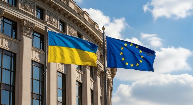 Flags of Ukraine and EU against a building and sky.