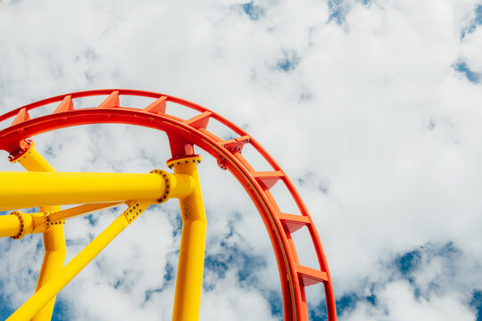Vibrant roller coaster track against clear blue sky