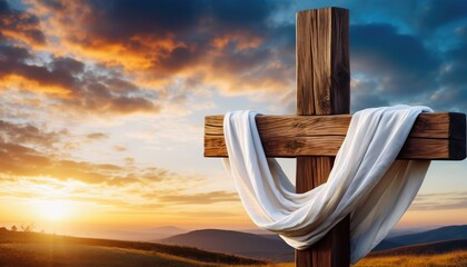 Wooden cross draped with white fabric against a dramatic sunset sky over rolling hills, symbolizing hope and resurrection.