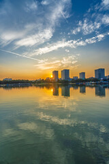 Fototapeta premium Sunset scenery by the city lake