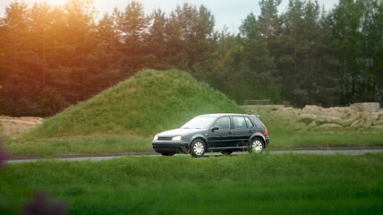 Fototapeta premium White urban vehicle driving near field