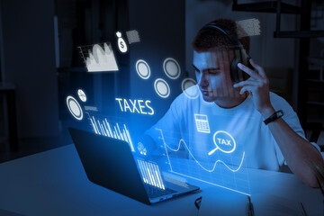 Young man working on tax calculations with virtual data visualization at home