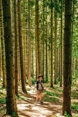 Summer trip to the mountains. A woman walks in the forest in summer.
