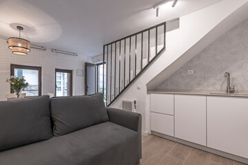 Fototapeta premium Photograph showing the construction details of a traditional brick fireplace, with benches on both sides and irregular stone cladding.