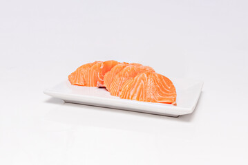 Mixed Japanese sashimi with translucent slices of squid, octopus, and tiger shrimp on a bed of daikon radish