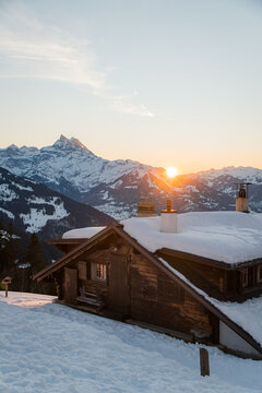 Winter sunrise over snowy Swiss mountain landscape