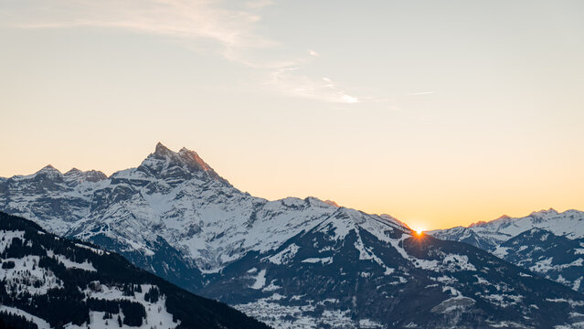 Snowy Swiss mountains at sunrise with clear skies