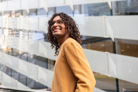 Urban lifestyle of a smiling non-binary individual