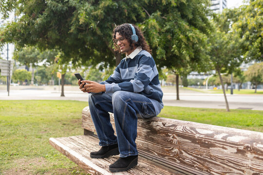 Relaxed non-binary person enjoying outdoor city life