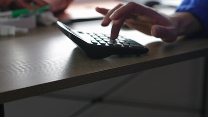 An accountant uses a calculator to calculate profit and income.
A person at a desk calculating finances using a calculator.
Using a calculator.
Math, calculator, profit, income, money, economics - Powered by Adobe