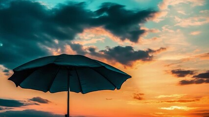 A blue umbrella sits atop a sandy beach, providing shade and protection from the elements