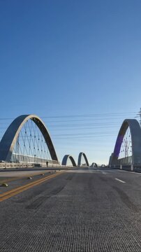 Early morning driving view crossing the new 6th Street Bridge near downtown Los Angeles in Southern California.  Vertical view.
