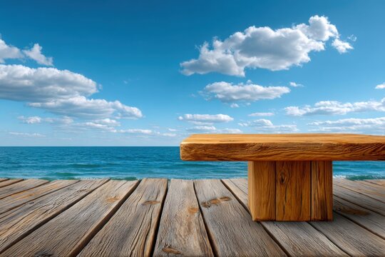 Rustic wooden table and pier overlooking a calm blue ocean under a cloudy sky