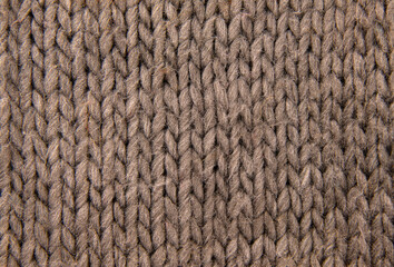Texture of brown knitted scarf close-up. Background texture.