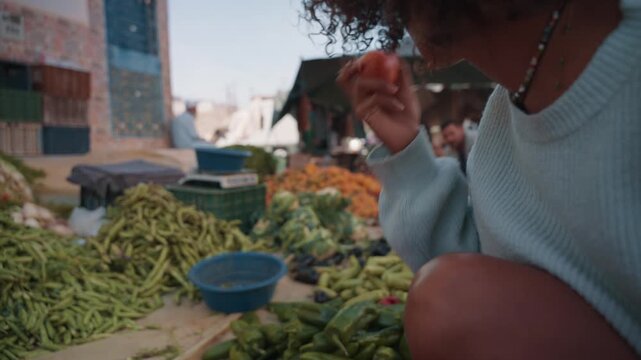Woman enjoying fresh produce at taghazout market