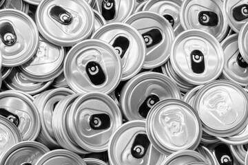 pile of empty aluminum beer or beverage can lids.  lids are stacked haphazardly on top of each other and are all the same size.