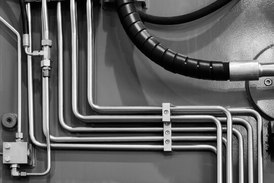 Many rubber tubes for high pressure as part of power hydraulic or pneumatic system of industrial machine, industrial concept background