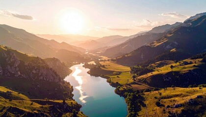 A breathtaking aerial view of a mountain landscape at sunset, featuring a calm blue river reflecting the golden light and lush green hills.