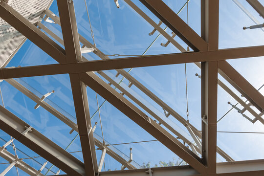 Steel-Framed Triangular Glass Skylight Pattern Under Blue Sky – Modern Architectural Roof Geometry. Ideal for architects, developers, and high-end contemporary construction presentations.