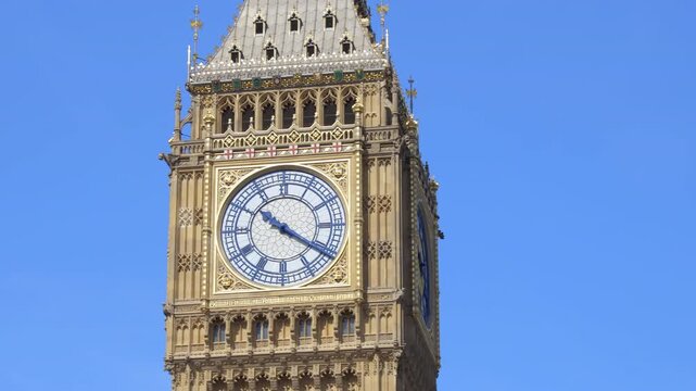 Close-up of Big Ben clock face under bright sunlight in London on a sunny day