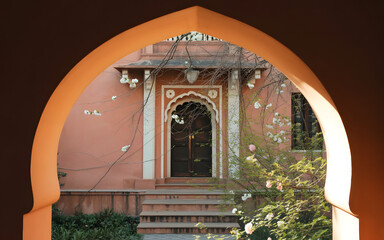 Spring Festival Courtyard Arch Backdrop with Blossoms, Vines and Warm Sunlight