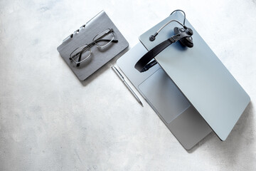 Headset and laptop top view. Customer support equipment at call center. Online conference. Online education concept