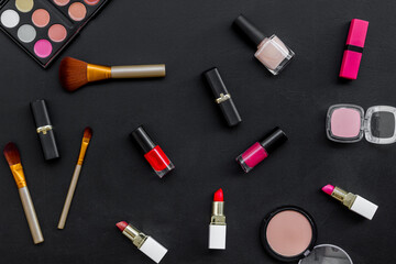 Pattern of various makeup tools and cosmetics products. Blusher, mascara, lipstick, nail polish and brushes, top view