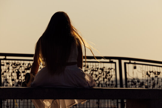 Woman gazing at Lisbon sunset over Bairro Alto