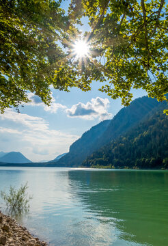 Scenic view of Lake Sylvenstein with sunrays through trees in Bavaria, Germany