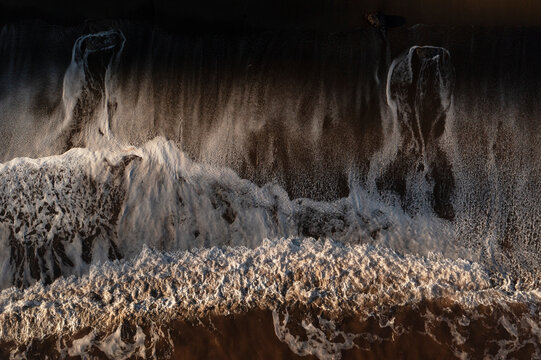 Top view of Asturias beach with dark sand patterns
