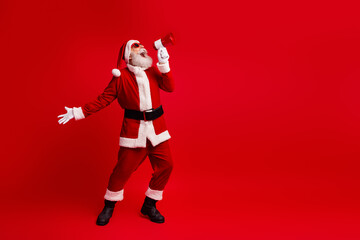 Santa Claus in vibrant red costume joyfully announcing with megaphone, ready for holiday celebrations and spreading Christmas cheer