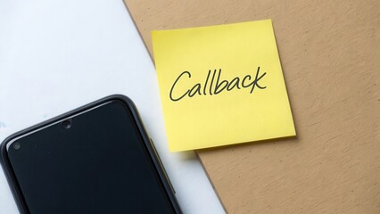 Yellow sticky note labeled Callback near a black smartphone