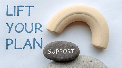 Clay arc hovering above pebble with support quote