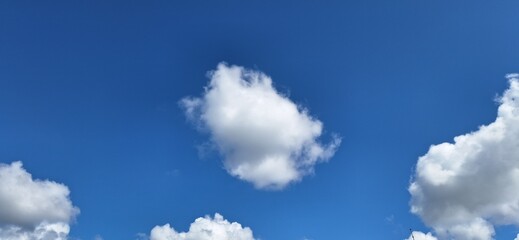 Sunny Blue Sky Background: Fluffy White Cumulus Clouds on a Clear Day