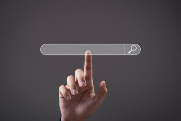 A hand pointing at a digital search bar interface on a dark background, symbolizing online searching, internet browsing, data lookup, web navigation, and modern digital technology interaction.