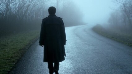 Lone figure walking into mysterious fog, cinematic suspense, perfect for thriller or mystery movie scenes, man in trench coat on desolate road, eerie atmosphere, suspenseful journey