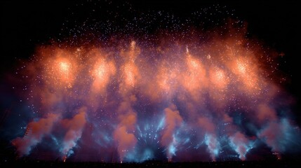 Photograph of a fireworks display at night. the sky is filled with vibrant colors of orange, pink, and blue, with the orange being the dominant color.