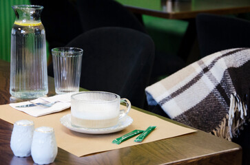 Cozy Caf&eacute; Table with Hot Drink and Lemon Water