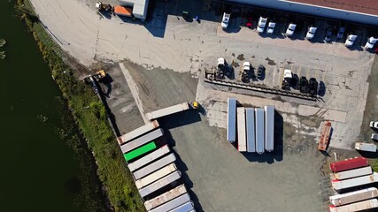 Aerial View Logistics Park With Warehouses Halifax Nova Scotia Canada. Drone Footage Showing Large Industrial Hub With Semi Trucks And Cargo Trailers Parked At Loading Ramps During Sunset In Halifax. - Powered by Adobe