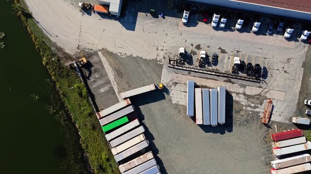 Aerial View Logistics Park With Warehouses Halifax Nova Scotia Canada. Drone Footage Showing Large Industrial Hub With Semi Trucks And Cargo Trailers Parked At Loading Ramps During Sunset In Halifax.