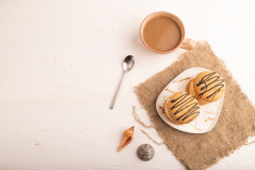 Caramel Cream Cakes on white wooden, linen textile, cup of coffee, top view, flat lay, copy space