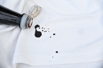dirty black sauce stain on white shirt in daily life. stain for cleaning concept.