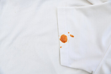 dirty spicy food sauce stain on white shirt in daily life. stain for cleaning concept.